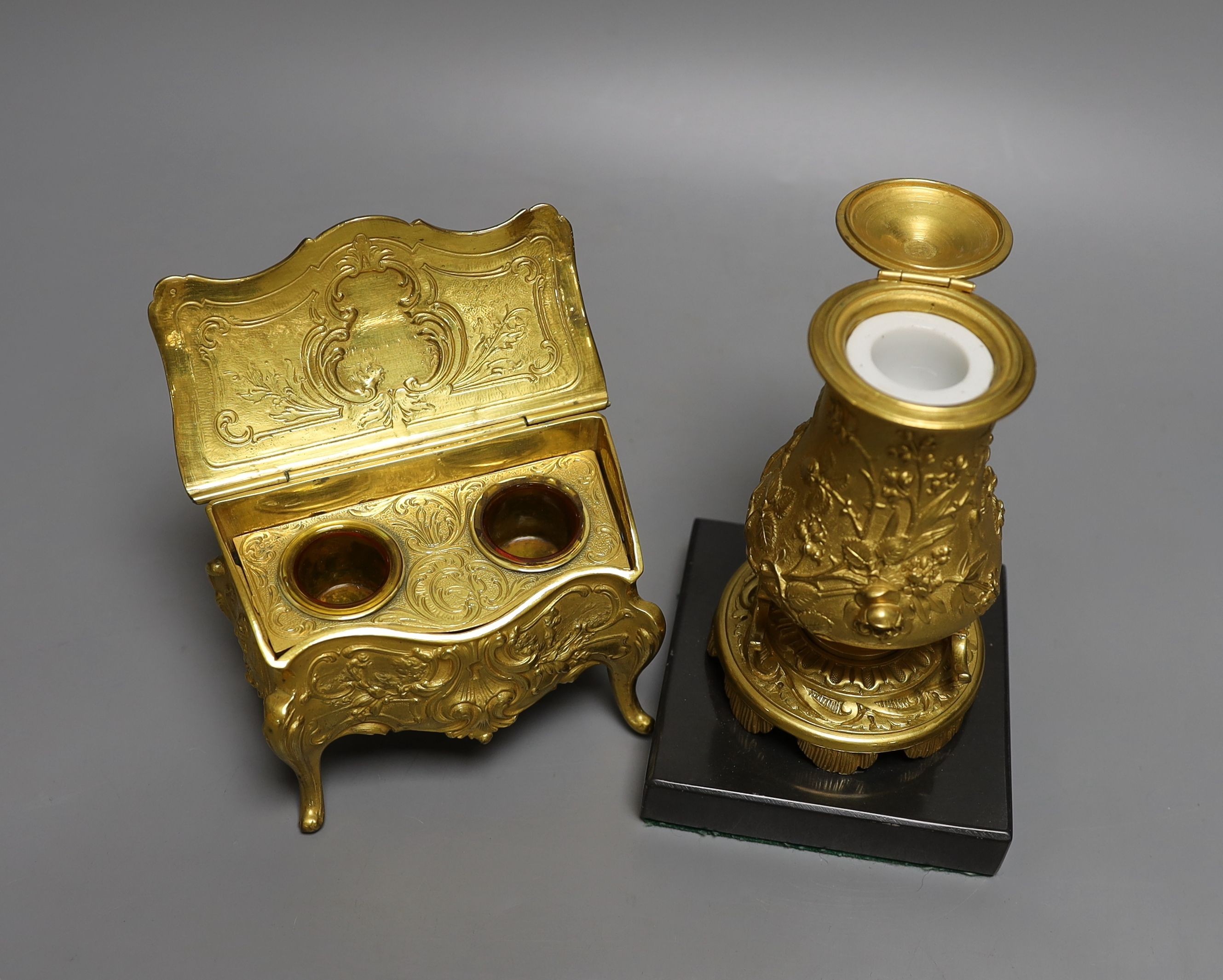 A novelty gilt metal, serpentine shaped miniature chest inkwell and a similar urn shaped inkwell, Chest 11 cms wide.